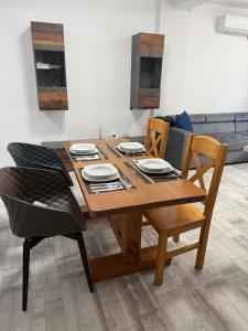 a wooden dining room table with chairs and a couch at La Lumina in Lumina