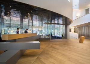 two people sitting at a counter in a lobby at Maistra Select Family Hotel Amarin in Rovinj