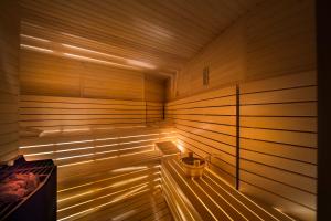 a wooden sauna with a yellow bucket in it at Maistra Select Family Hotel Amarin in Rovinj