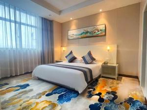 a bedroom with a large bed and a large window at Kunshan Yuxing Hotel in Kunshan +237 photos