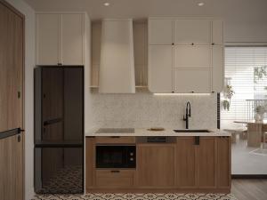 a kitchen with white cabinets and a black refrigerator at Cozy Room Featuring Local Rattan & Bamboo in Ho Chi Minh City