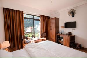 Ένα ή περισσότερα κρεβάτια σε δωμάτιο στο Thanh Phương Hotel 2 Hà Giang +12 φωτογραφίες