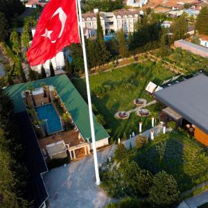 a flag on top of a house with a garden at BK Hotel in Fethiye