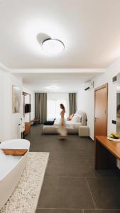 a woman is running through a hotel room at BK Hotel in Fethiye