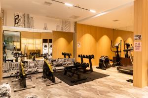a gym with several treadmills and exercise equipment at Fengqi Wutong Holiday Hotel - Changsha Wuyi Avenue Railway Station Metro Station Branch in Changsha