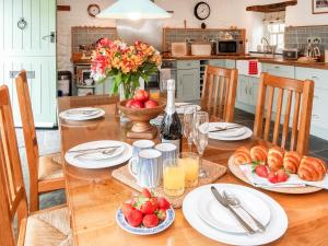 a table with plates of food and fruit on it at Ty Menyn in Mathry