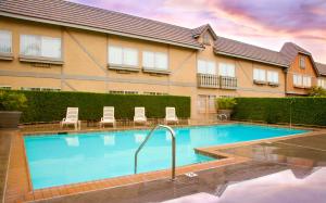 a large swimming pool in front of a building at Folk Inn Ontario Airport in Ontario