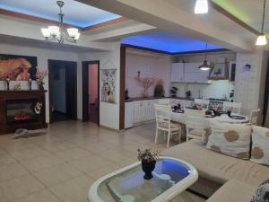 a living room and kitchen with a couch and a table at Luxury central in Craiova