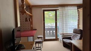 a living room with a door open to a balcony at Haus Stöckl Top 14 in Königsleiten