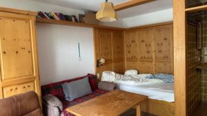 a room with a bed and a table in it at Haus Stöckl Top 14 in Königsleiten