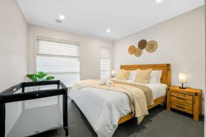 a bedroom with a large bed and a window at Seednest BBQ Cozy Family house in Alfredton