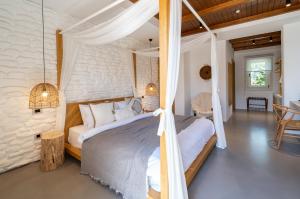 a bedroom with a canopy bed in a room at Nomad Boutique Hotel Side - Adults Only in Side