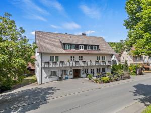 a large white house on the side of a street at Landgasthof Rössle in Kressbronn am Bodensee
