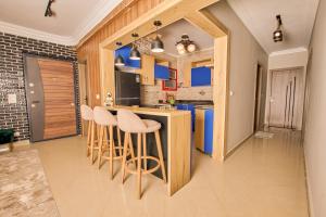 a kitchen with a bar with stools in it at Atta pyramid view inn in Cairo