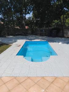 a blue pool in the middle of a patio at Viva Guest House in Trevallyn
