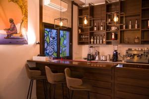 a bar in a restaurant with chairs around it at Aichti Hotel in Abidjan