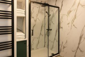 a shower with a glass door in a bathroom at Kenn Valley View in Doddiscombsleigh +19 photos