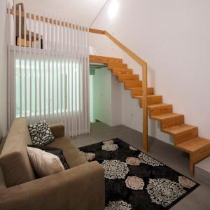 a living room with a couch and a staircase at Casal de Palácios in Bragança
