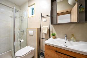 a bathroom with a sink and a toilet and a shower at Apartment Fortuna in Trpanj +37 photos