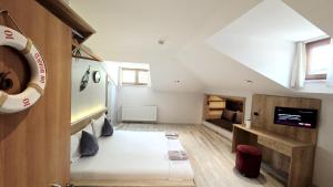 a small room with a bed and a tv at 3A House - Sultanahmet in Istanbul