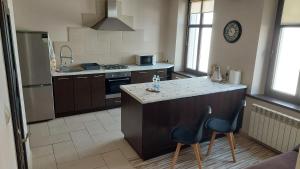 a kitchen with a island with two chairs in it at MagMar Studio rynek Kluczbork in Kluczbork