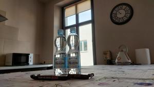 two bottles of water sitting on top of a table at MagMar Studio rynek Kluczbork in Kluczbork +10 photos