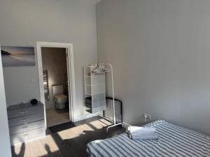 a bedroom with a mirror and a bed and a dresser at Chris cosy retreat in Buckinghamshire +5 photos