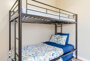 a bunk bed in a room with a bunk bedsheet at Chic 2BR Apartment Near Branch Brook Park in Newark