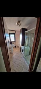 a bathroom with a shower and a toilet and a sink at Casa di Mike in Canegrate