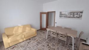 a living room with a couch and a table and chairs at Sunrise in Bergamo