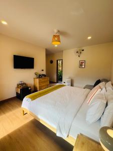 a bedroom with a large bed and a flat screen tv at The Proud Resort Riverside Cafe Sapan-nan in Ban Huai Ti +25 photos