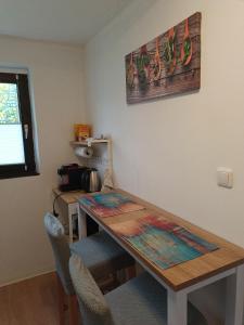a table and chairs in a room with a table at Ferienwohnung Schack in Hoisdorf +3 photos