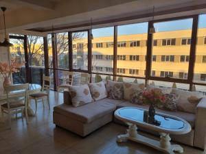 a living room with a couch and a table at Luxury central in Craiova