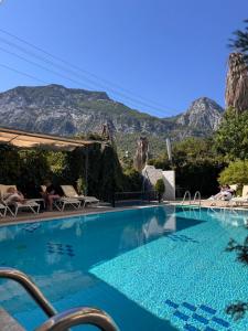a swimming pool with mountains in the background at BEGONYA HOTEL KEMER-All İnclisuve in Antalya