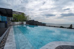 ein großes Schwimmbad auf dem Dach eines Gebäudes in der Unterkunft Bluphere Residence by Prop Hopper in Na Jomtien