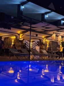 a room with a pool and chairs and lights at BEGONYA HOTEL KEMER-All İnclisuve in Antalya +83 photos