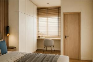 a bedroom with a bed and a chair and a desk at Ban Chang Pet-Friendly Hotel in Ban Chang