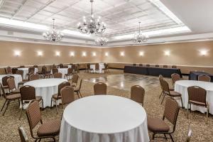 a banquet room with tables and chairs and chandeliers at Comfort Suites Bethlehem Near Lehigh University and LVI Airport in Bethlehem