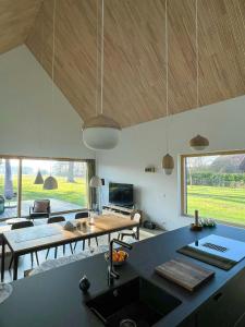 a kitchen and living room with a table and a couch at Architect's House With Nature View 