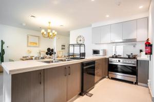 a kitchen with a sink and a stove top oven at Luxurious 3 BR with Burj Khalifa View in Downtown in Dubai