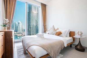 a bedroom with a bed and a large window at Luxurious 3 BR with Burj Khalifa View in Downtown in Dubai +60 photos