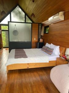 a bedroom with a large bed with a large window at Lá Homestay in Ðak Lao +75 photos