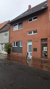 a brick building with a sign in front of it at HYGGE HOMES - Apartment 'Stilla' in Celle