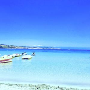 a group of boats in the water on a beach at Seafront apartment 2 bedrooms Terrace & Panoramic ocean views in Is-Sellum