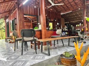 a room with chairs and a table and a bar at Bụi Tre Homestay in Ben Tre +15 photos