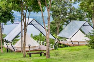 a couple of tents in a park with a bench at The Hilltop Erawan in Si Sawat +22 photos