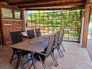 a dining room with a wooden table and chairs at Paradise for children, Family apartment Oros Medulin, with a pool, gd in Medulin