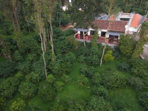 an aerial view of a house in the woods at Nila by Raho - Secluded Villa with Estate View in Siddapur +75 photos
