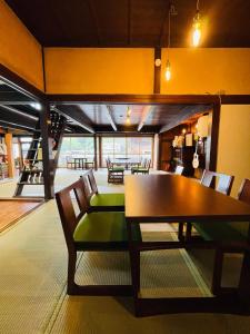 a dining room with a table and chairs at 萩市の静かな港町の一棟貸切宿 泊まれるカフェ 龍さん家 -Japanese traditional house- in Hagi +18 photos