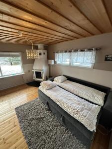 a bedroom with a large bed and a wooden ceiling at Camp Caroli Olala in Jukkasjärvi